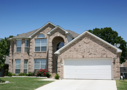 This is a home with a white aluminum garage door.